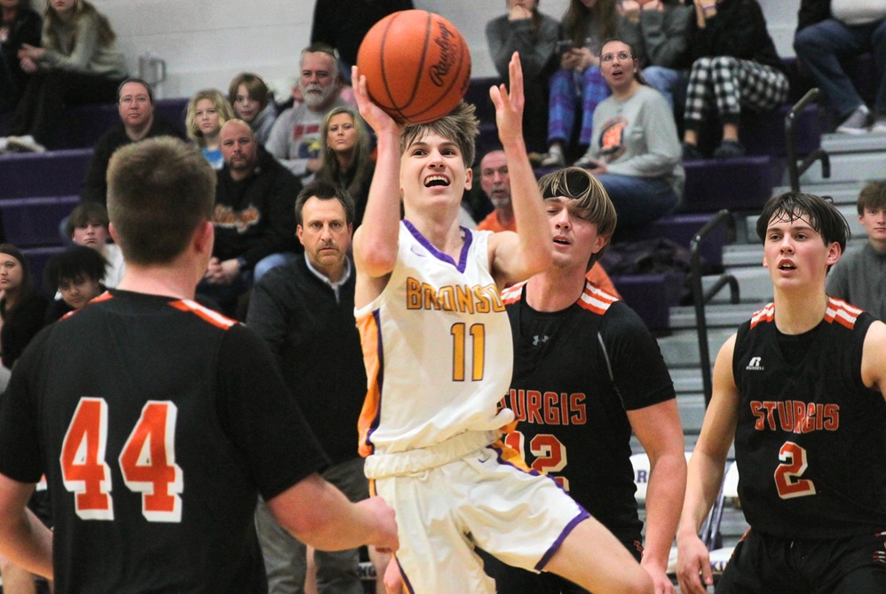  Bronson senior point guard Kam Brackett (11) looks to score against Sturgis during a game his junior season.