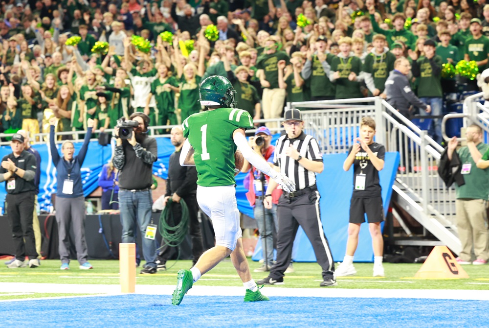 Zeeland West's Keaton Hendricks scores a touchdown in front of the Zeeland West student section at Ford Field.