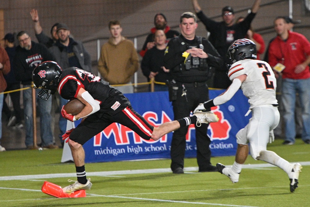 Forest Park’s Nik Stephens (22) gets to the pylon for one of his three touchdowns Nov. 23 at Northern Michigan University.