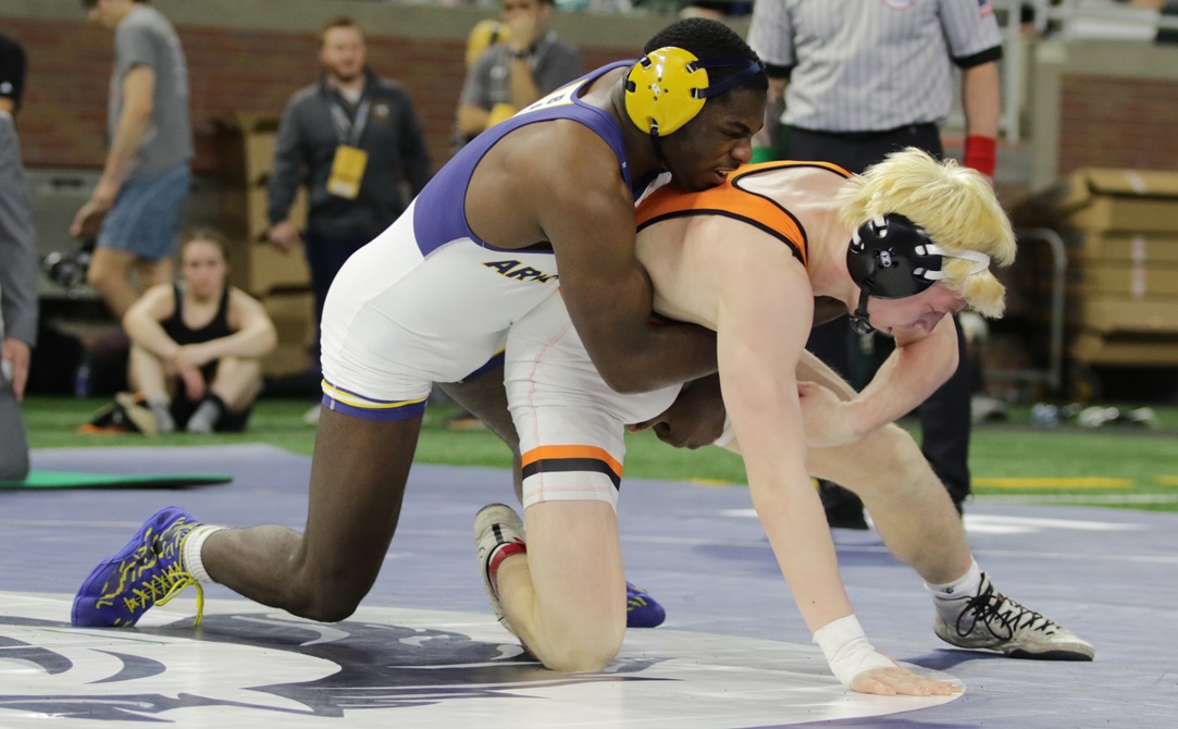 Saginaw Arthur Hill’s Michael Baldwin (left) wrestles Byron Center’s Blake Ottow during a third-place match at last season’s Individual Finals. 