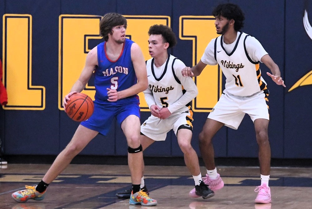 Mason’s Cason Carswell (5) considers his options during a 65-63 win over Haslett on Friday, as the Vikings’ Wardrell Wicker (5) and Rishon Karikalan (21) defend.