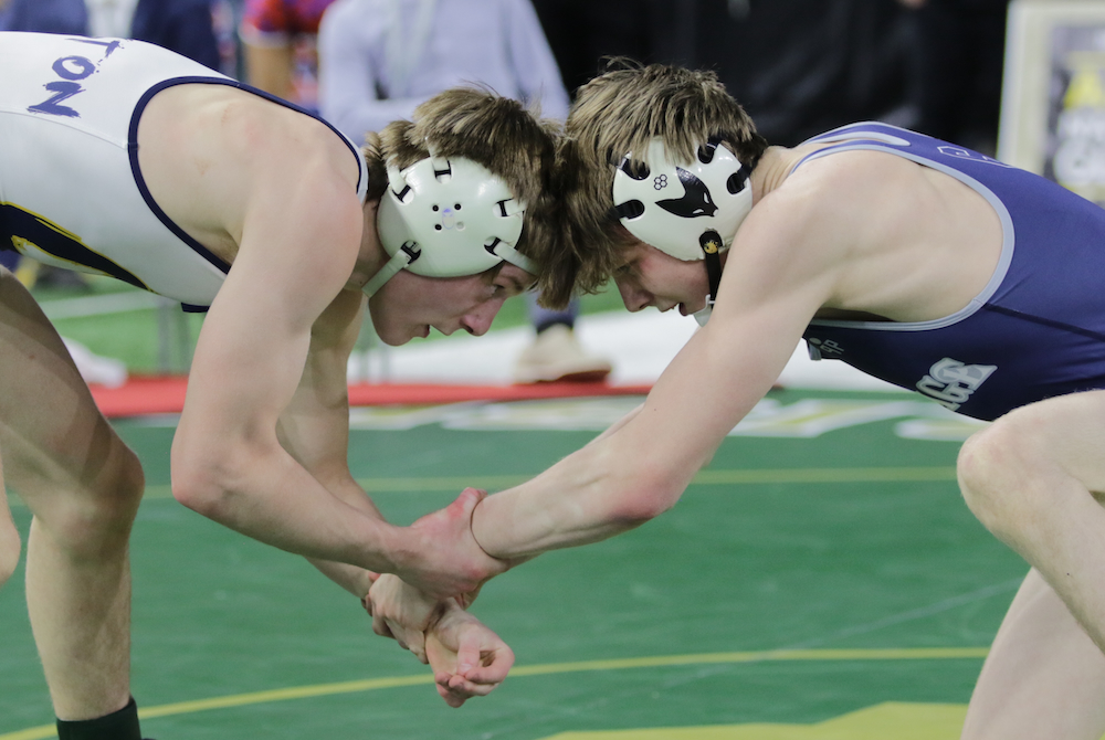 Clarkston teammates Archer Anderson (left) and Preston Lefevre compete against each other for the Division 1 championship at 120 pounds last season.