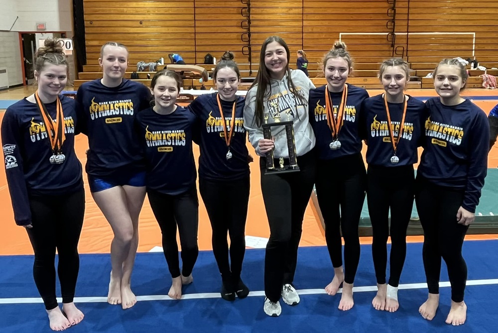 The Bark River-Harris gymnastics team takes a photo after finishing runner-up at the Escanaba Elks Invitational.