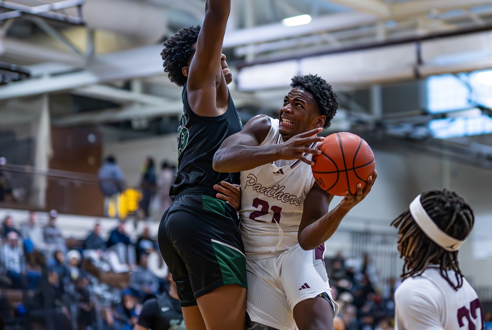 River Rouge's Roland Berry III (21) drives to the basket against Birmingham Groves on Dec. 30. 