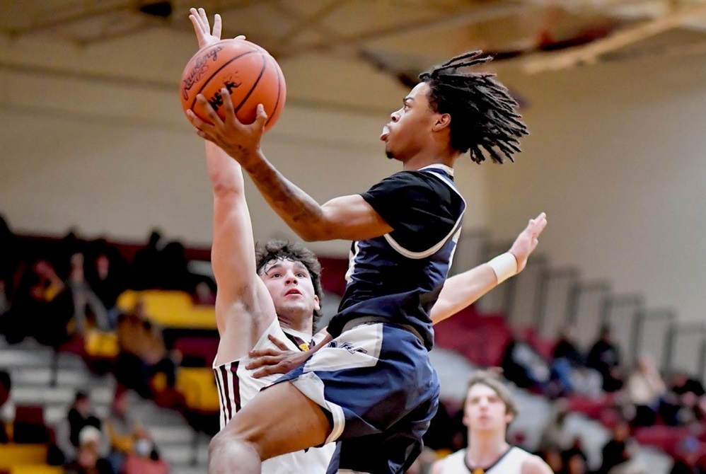  A Mt. Morris player soars toward the basket during his team's 70-42 loss at Davison last week. 