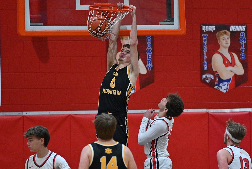 Iron Mountain's Oskar Kangas (0) dunks the ball off a fourth-quarter inbounds pass during his team’s 58-32 win over Ishpeming Westwood on Thursday. 