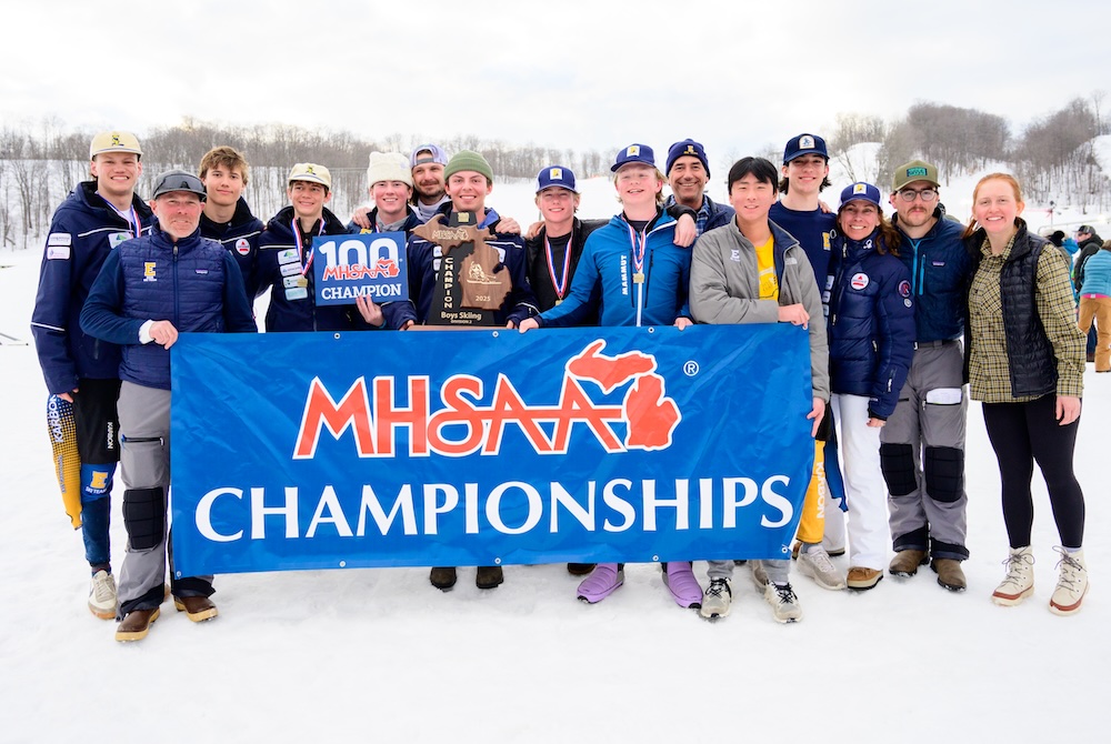 The East Grand Rapids boys ski team hoists its trophy after winning the Division 2 title Monday at Boyne Highlands.