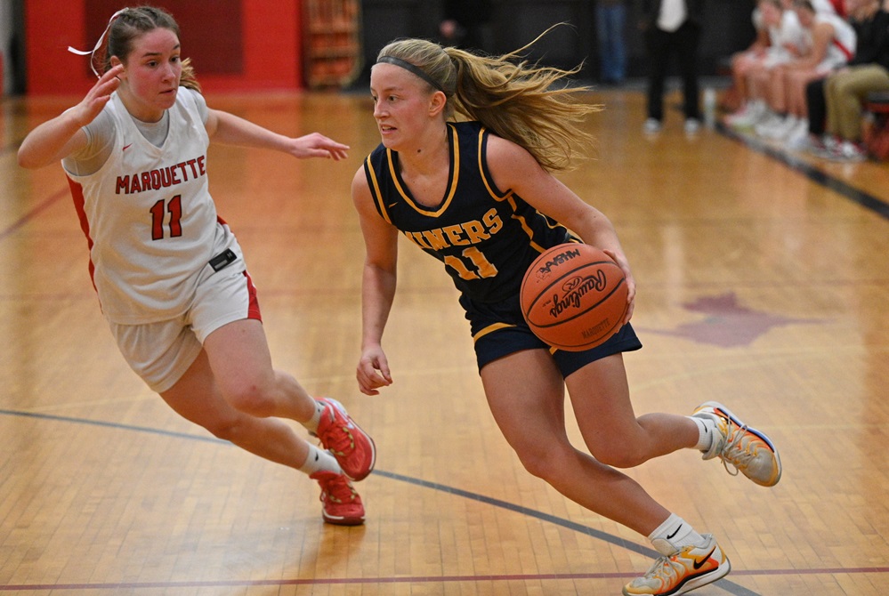 Marquette's Alexis Curran defends Negaunee's Aubrey Johnson as she drives towards the basket during the Miners' 48-22 win on Feb. 14. 