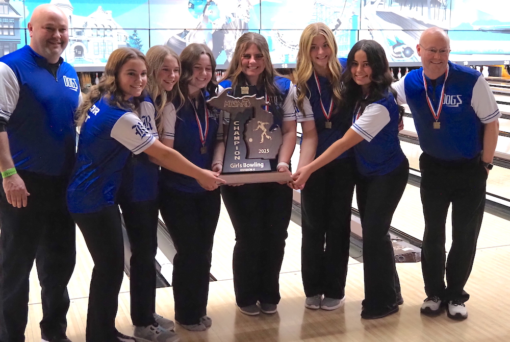 The Ravenna girls bowling team holds up its championship trophy.