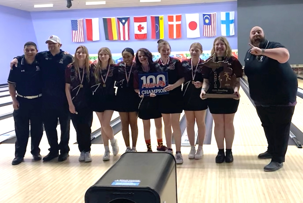 The Grandville girls bowling team poses with its championship trophy.