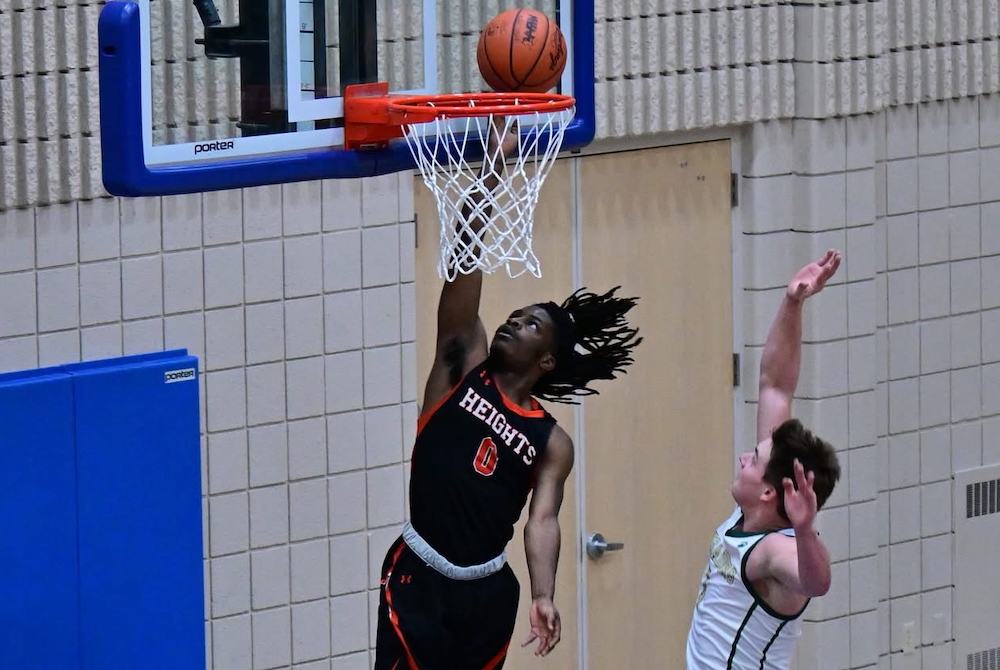 Muskegon Heights Academy’s Cartier Vance (0) gets to the rim during his team’s 59-46 District Final win Friday at Fruitport Calvary Christian. 