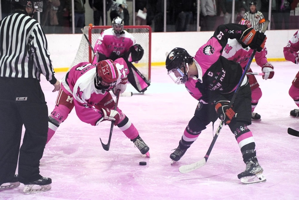 Orchard Lake St. Mary's and Bloomfield Hills Brother Rice players face off during their Pink in the Rink game Feb. 8. 