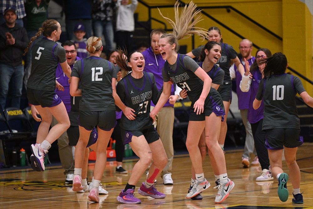 Gladstone players including Lillie Johnson (21) and coaches celebrate their Division 2 District Final win over Negaunee on Friday. 