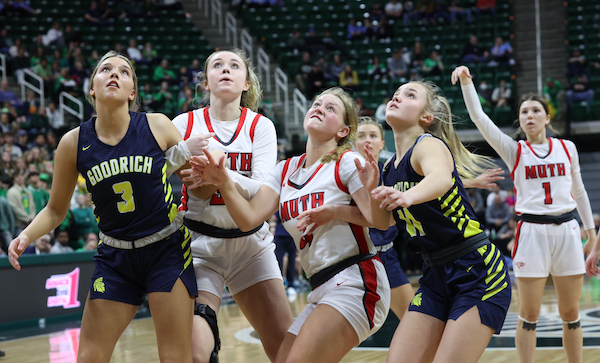 Goodrich's Kalen Williams (3) and Alexis Kosmowski (11) and Frankenmuth's Lexi Boyke (33) and Izzy Bernthal (4) work for position as they await a rebound. 