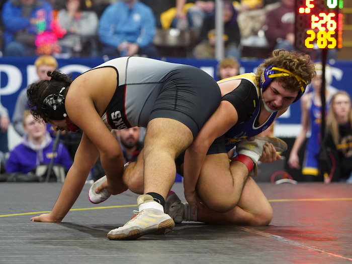 Bronson’s Matthew Blankenship, right, and St. Louis’ Ramon Anguiano lock up at 285 in a Semifinal.