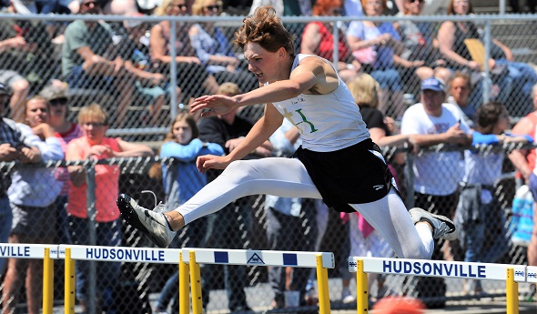 Hackett clears a hurdle during the 2019 MHSAA Finals.