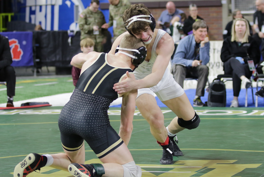 Davison’s Justin Gates, right, wrestles teammate Tanner McDunnah en route to claiming his third title. 