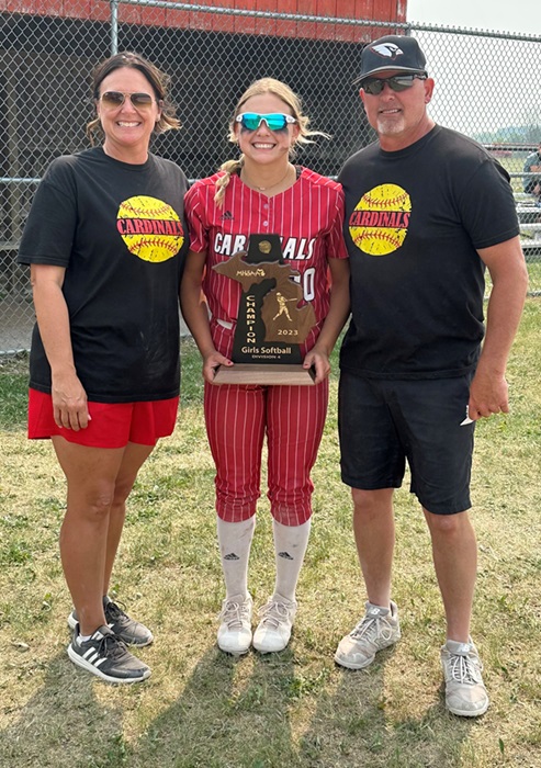 Marlatt celebrates a trophy win during last season’s Semifinals softball run with parents (and coaches) Kim and Ryan Marlatt.
