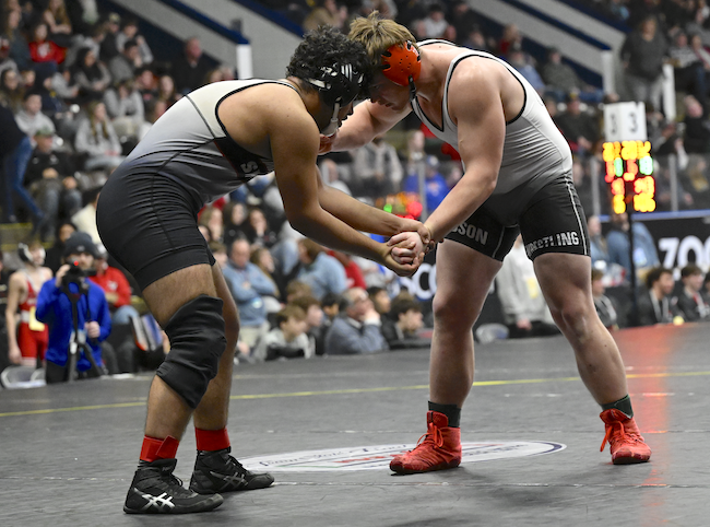 St. Louis’ Ramon Anguiano, left, and Hudson’s Cameron Miller lock up at 215 pounds. 