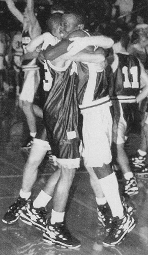 Glover, left, hugs teammate Doug Dozier after a victory over rival Muskegon Mona Shores in 1995-1996 basketball season opener. MCC finished 17-7 and a District champion. 