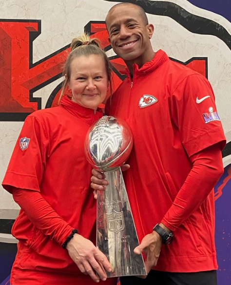 Glover poses with this year's Super Bowl Championship trophy alongside fellow Chiefs athletic trainer Julie Frymyer.