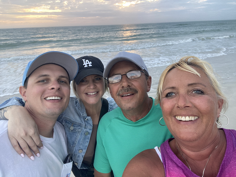 Darling and Danielle enjoy a sunset over the water with her parents. 