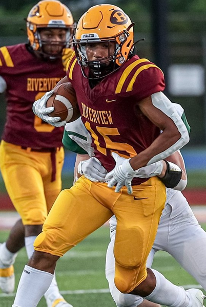  Ian Adams (15) attempts to break a tackle.