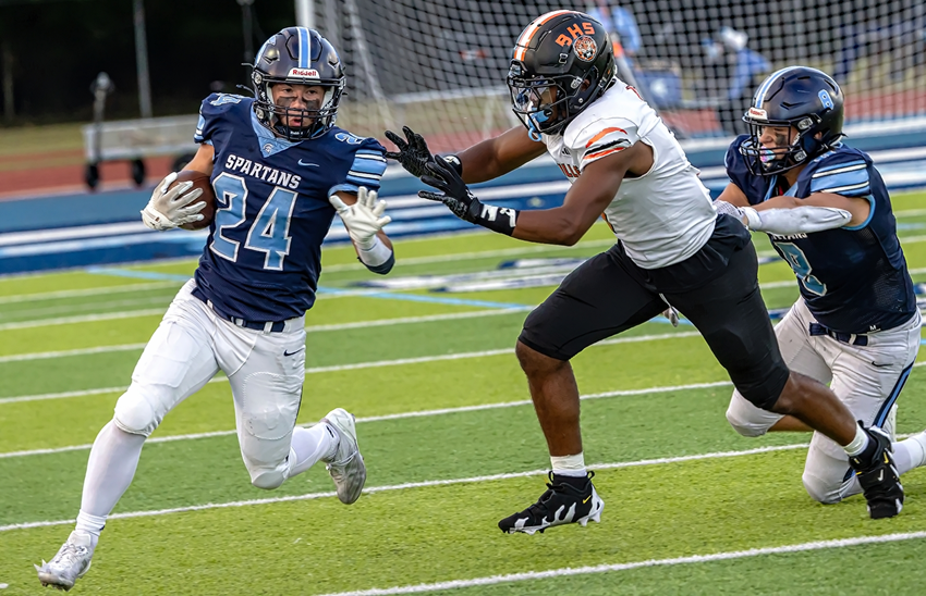 A Belleville defender closes in on Livonia Stevenson's Tasso Kotsogiannis (24).