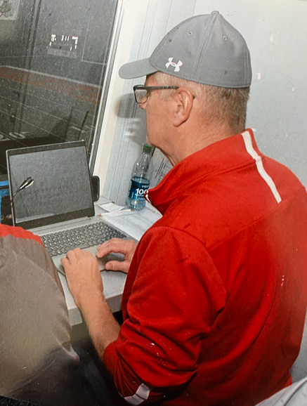 Rodammer does his work in the corner of the press box.