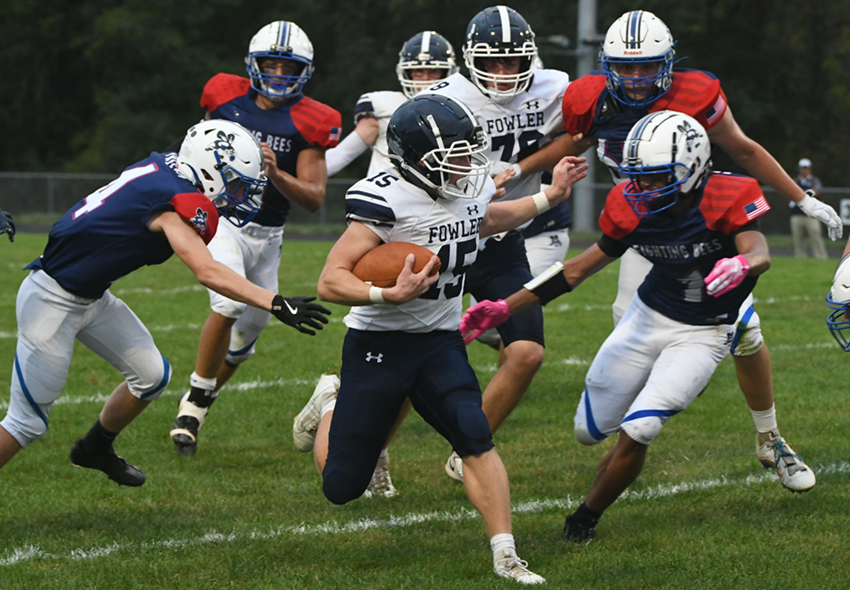 Fowler’s Ford Phillips (15) breaks into an opening but with Bath’s Isiah Delacruz (1) closing in. The Eagles won 41-0.