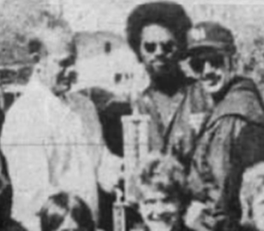 The Niles Daily Star published this 1976 photo of Lukens (back row, second from right) and coach Ted Duckett (back row, center) receiving the championship trophy at the Daily Star Relays from publisher Bill Applebee.