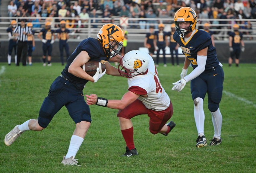 Negaunee's Brady Mager (4) takes on Hancock's Ethan Anderson (45) during the Miners’ 48-20 win. 