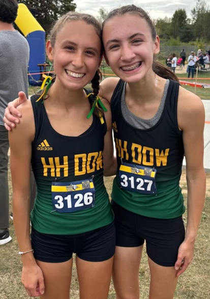 Victoria, left, and Emilia take a photo at a finish line.