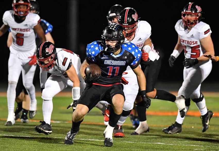 Chesaning's Brayden Florian (11) finds a seam during his team's 50-0 win over Montrose.