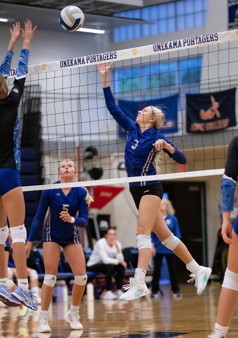 Leah Gary (3) works to get the ball past an opposing block.