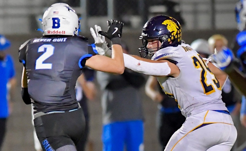 Goodrich's Chase Burnett (25) puts up a stiff arm as an Ortonville Brandon defender attempts to catch up with him.