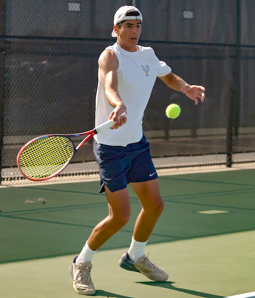 Rochester Hills Stoney Creek’s Quentin Rangi volleys during a Friday match at No. 2 singles. 