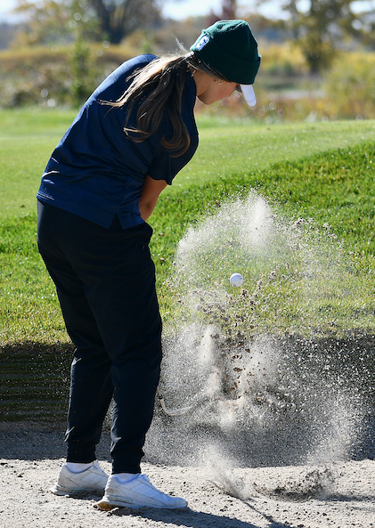 A competitor launches a shot from the sand.