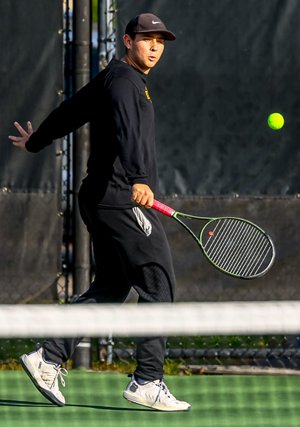 North Farmington's Jack Weingarden volleys during his first match at No. 3 singles. 