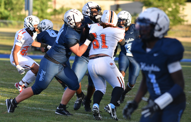 Dominianni (64) helps protect his backfield against Grand Rapids Ottawa Hills. 