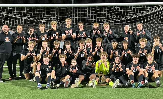 The Bulldogs take a team photo in front of their net.