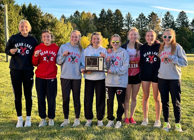 The Bear Lake girls team take a trophy photo after clinching the West Michigan D League title.