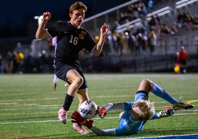 The Bulldogs’ Connor Jenks (16) tries to get a ball past Adams keeper Reid Dennis. 