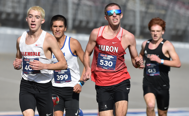 Allendale’s Mason Hill (403) and New Boston Huron’s Lucas Kuhn (530) race among the lead runners.