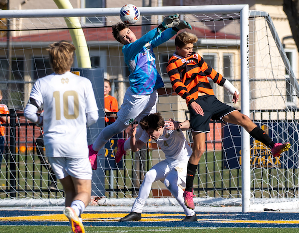 The Elks’ Tyler Standfest heads a shot that gets past Fighting Irish keeper Tomassino Offer.