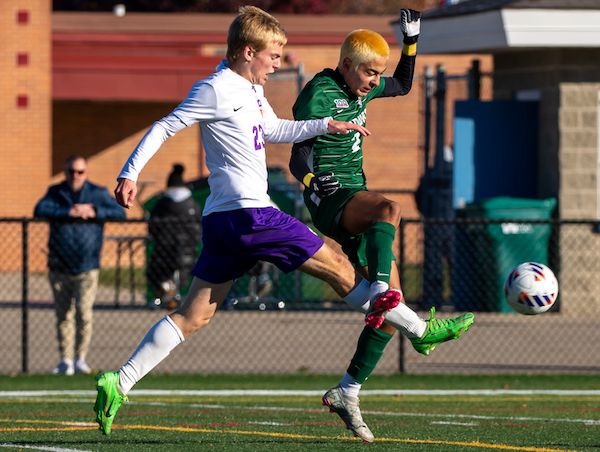 Plymouth Christian’s Grant Ramseyer (23) and WMC’s Juan DeJonge battle for possession. 