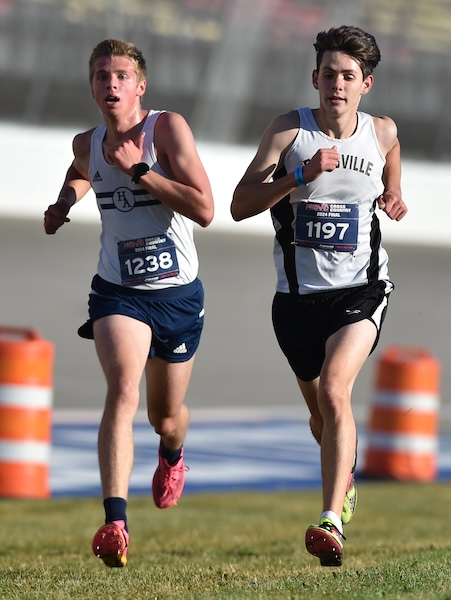 Hillsdale Academy’s Grayson Rorick (1238) and Dansville’s Theodore Davis sprint for position on the way to the finish line.