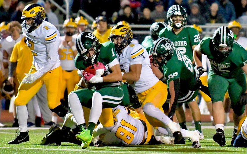 Clarkston’s Griffin Boman (0) wraps up Lake Orion’s Jayden Borrero.