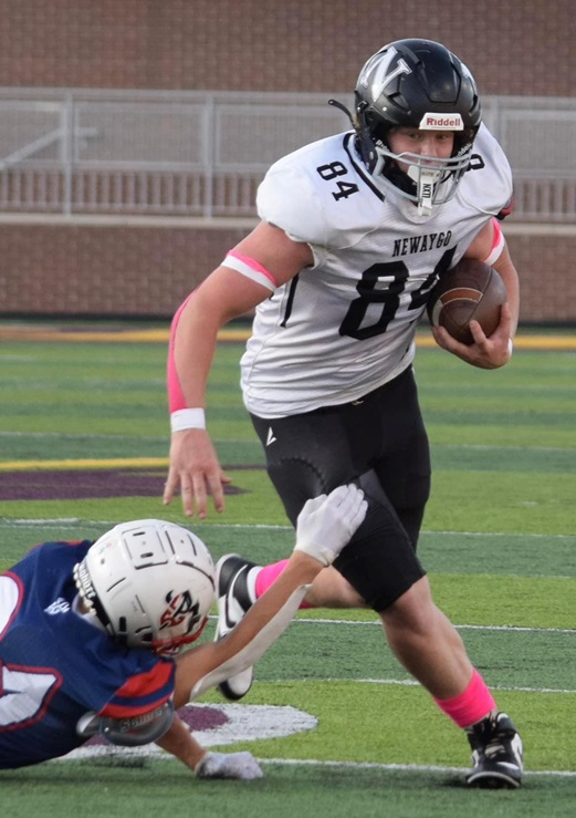 Senior tight end Henry Wood (84) works to get past an outstretched defender. 