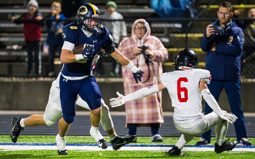 DeWitt’s Traverse Moore (2) eludes a Lowell defender during the Panthers’ 49-35 win in Division 3.